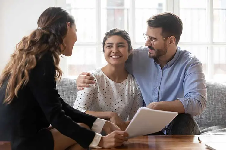 a couple embraces while receiving information from a doctor