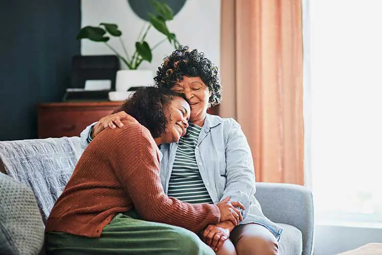 an older woman and her daughter embrace