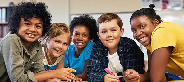 A group of teenagers and children smiling